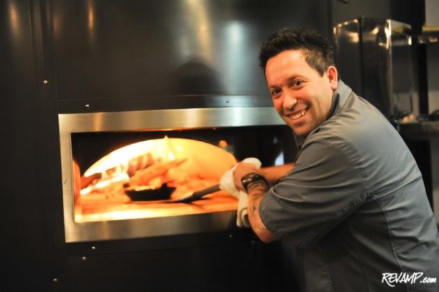 Chef Mike Isabella slides a skillet into Graffiato's massive wood oven.